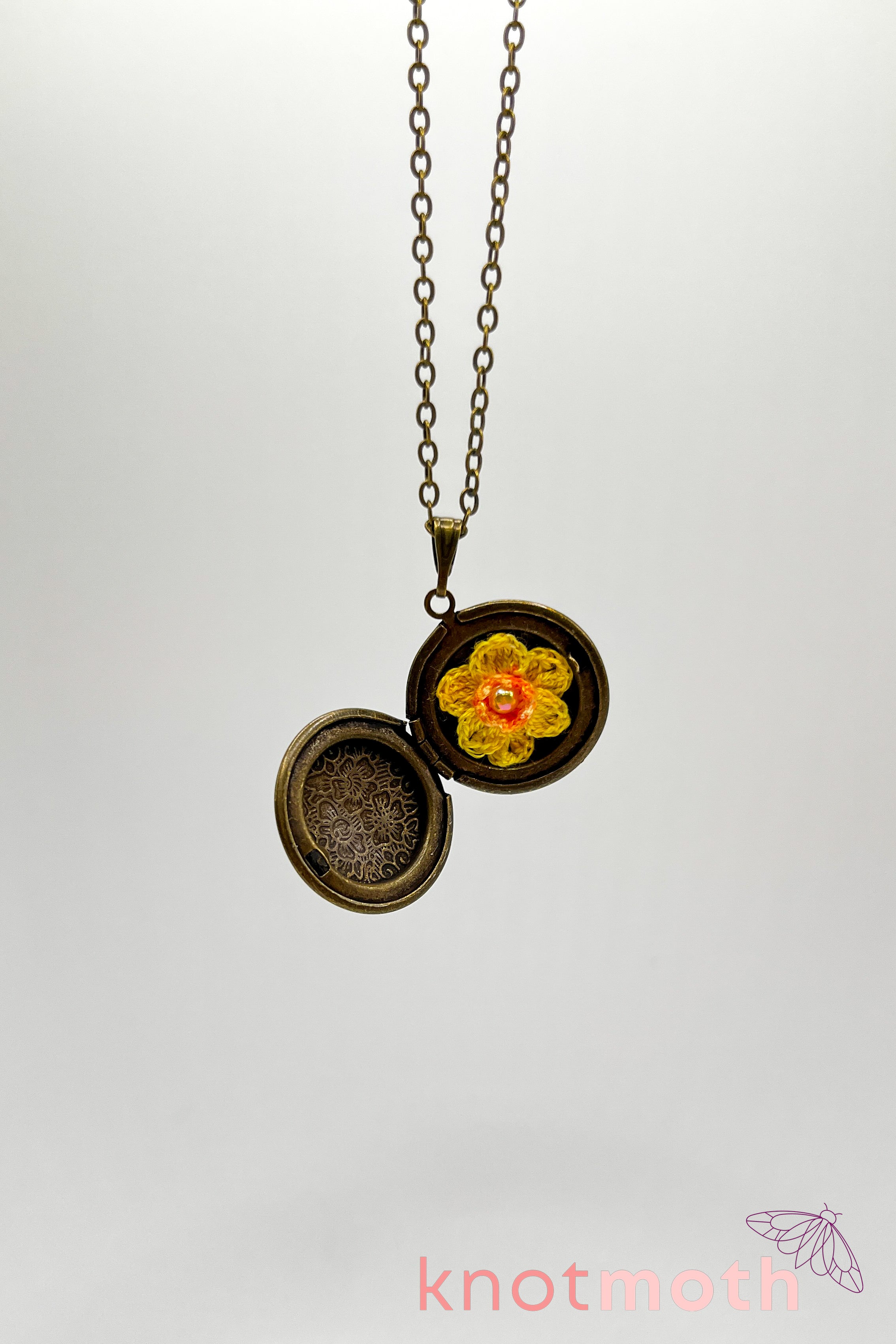 Daffodil (new beginnings) floriography microcrochet locket knot moth